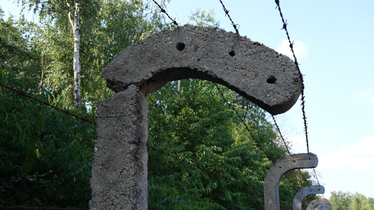 Close-up of the fence surrounding the grounds of the former prisoner-of-war camp in Lambinowice, Poland.