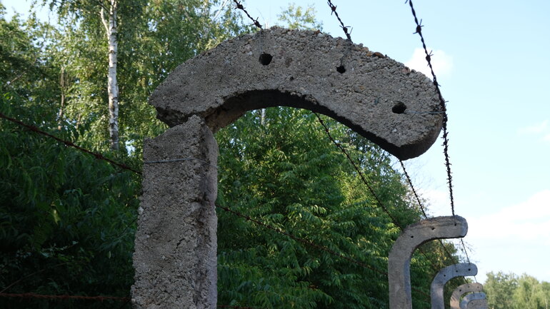 Nahaufnahme des Zauns, der das Gelände des ehemaligen Kriegsgefangenenlagers in Lambinowice, Polen, umgibt.