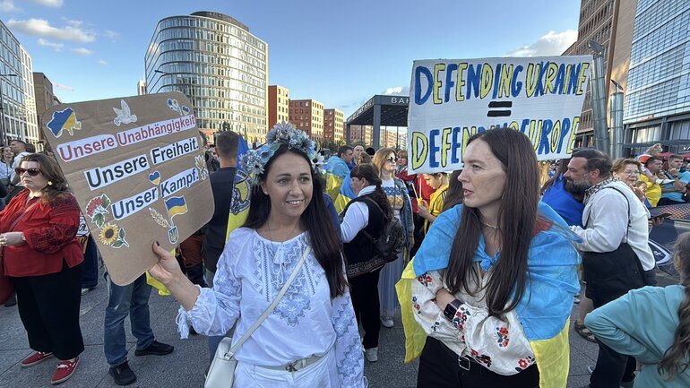 Demonstrators with banners on a public city square.