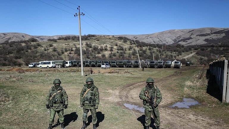 Russian soldiers stand guard an area outside the Ukrainian military base at the Perevalnoye outside Simferopol